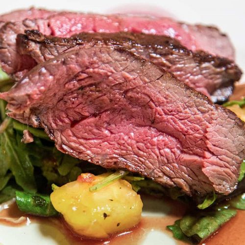 Air fryer roast beef on a white plate