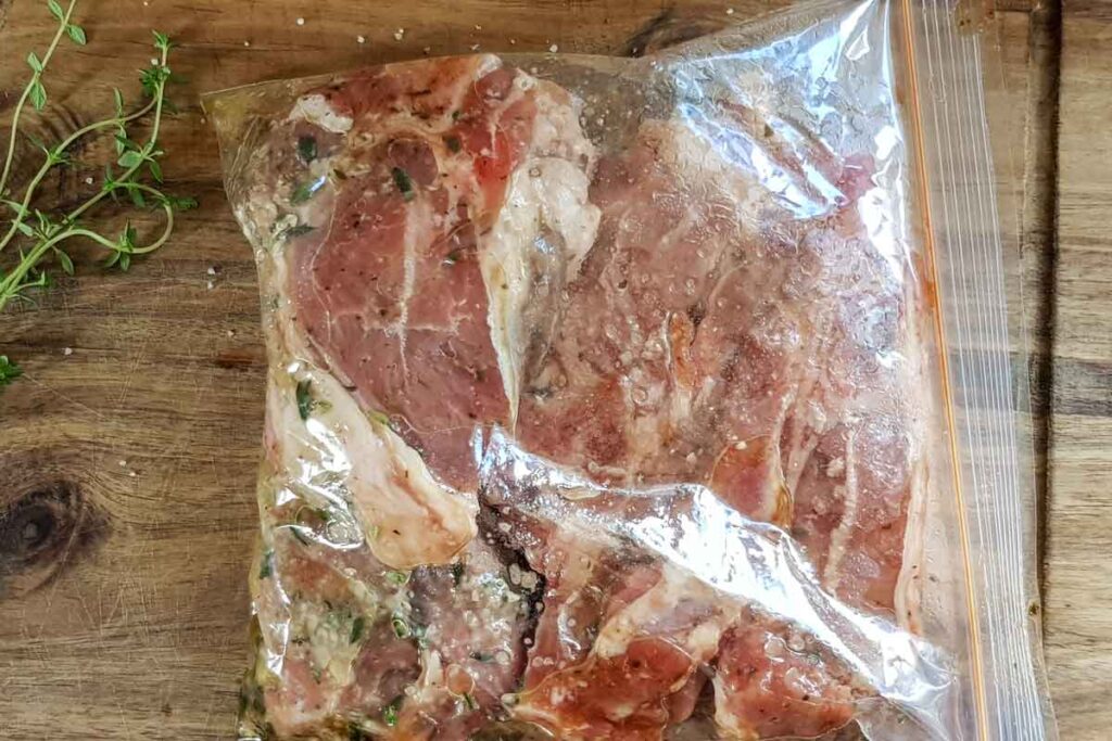 Lamb chops marinating in a zip lock bag. 