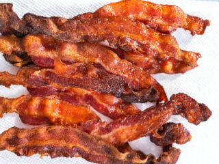 Crispy air fryer bacon on a white paper towel