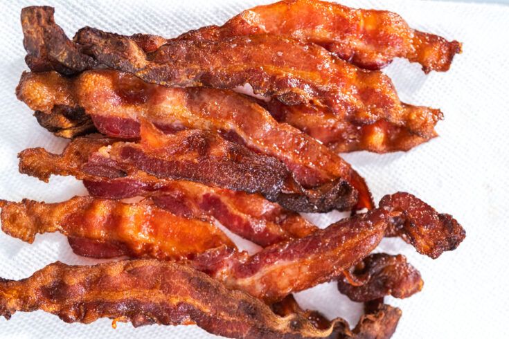 Crispy air fryer bacon on a white paper towel