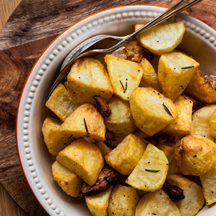 Crispy golden roast potatoes in a dish.