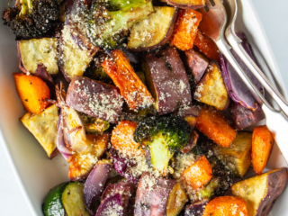 Flay lay photo of air fryer vegetables in a white serving dish.