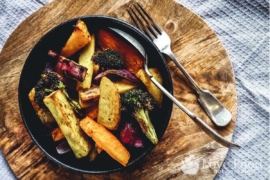 Air fried vegetables in a black bowl.