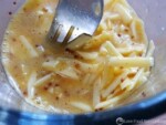 Egg, cheese and mustard mixed in a glass jug