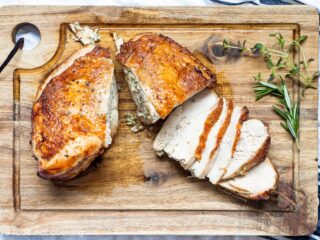 Air fryer turkey breast sliced on a wooden board