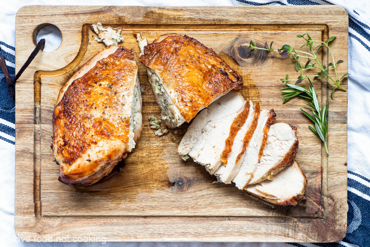 Air fryer turkey breast sliced on a wooden board