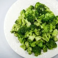 Microwave steamed broccoli on a white plate