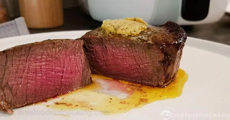 Medium rare air fryer steak, sliced, showing interior. 