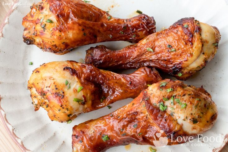 Air fryer chicken drumsticks on a cream-colored plate
