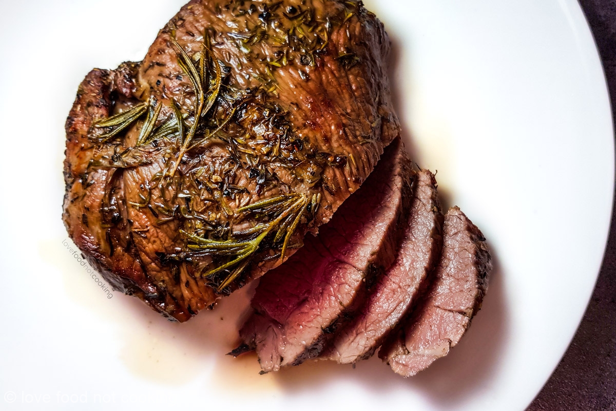 Air fryer roast lamb on a white plate