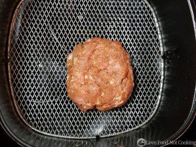 Pork burger in air fryer basket