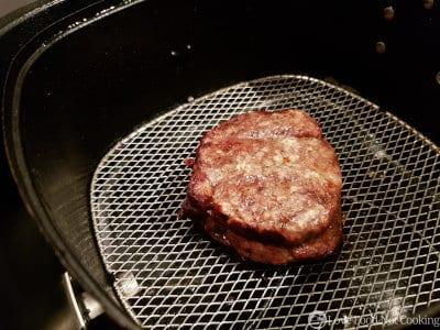 Air fried steak in the air fryer basket. 