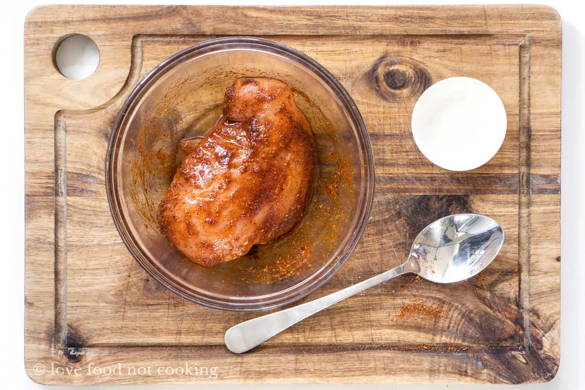Seasoned chicken breast in a bowl. 