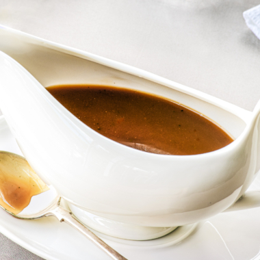 Gravy made from stock in a white gravy boat.