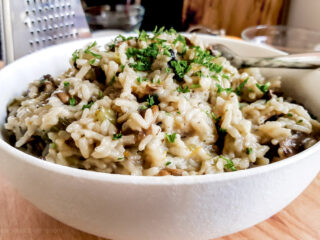 Instant Pot mushroom risotto in a white bowl.