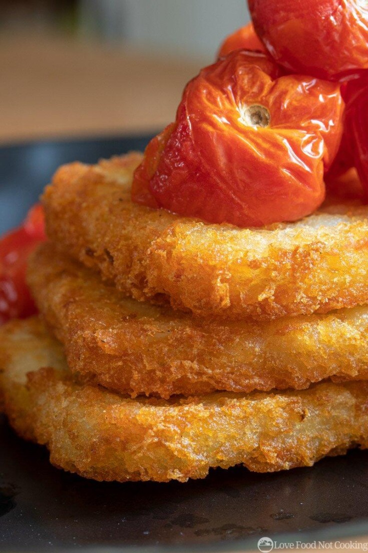 Air fried hash browns on a plate with roasted tomatoes