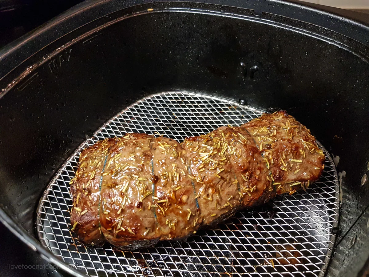 Air fried beef tenderloin in air fryer basket. 