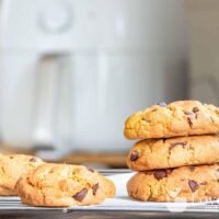 Cookies baked in an air fryer, with an air fryer in the background.
