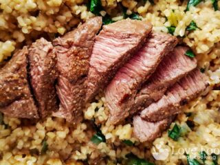 Air fried lamb steaks on a bed of couscous.