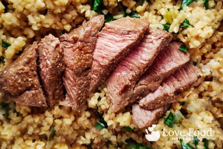 Air fried lamb steaks on a bed of couscous.