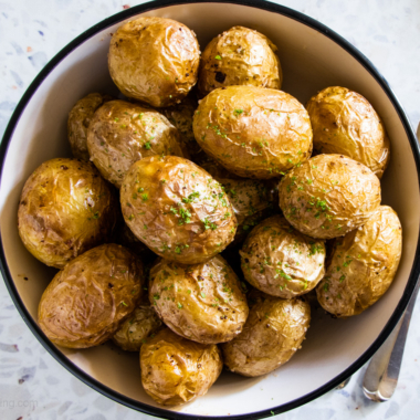 Air fryer baby potatoes in a white bowl.