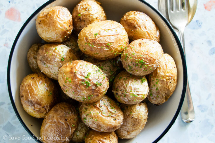 Air fryer small potatoes in a white bowl.