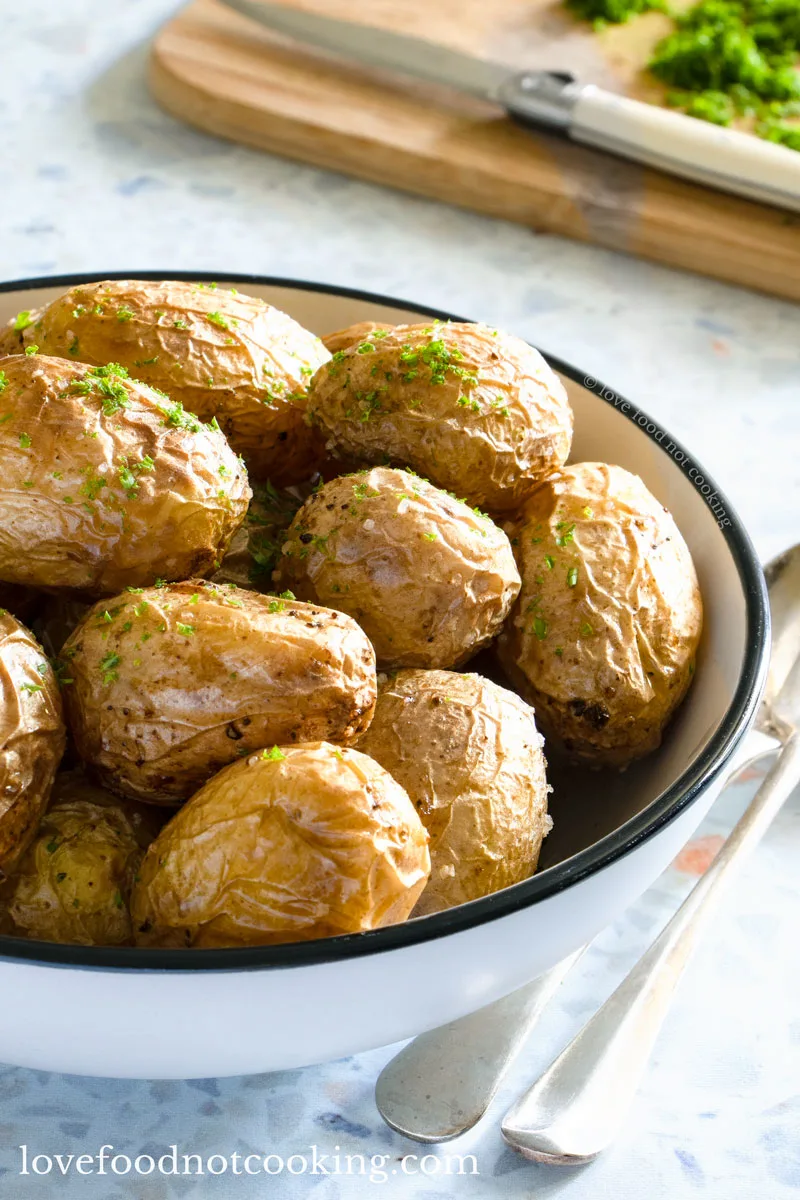 Air fryer mini potatoes in a white bowl.