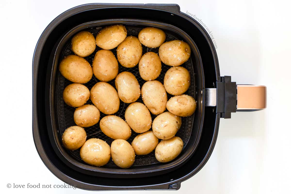 Small potatoes in air fryer basket. 