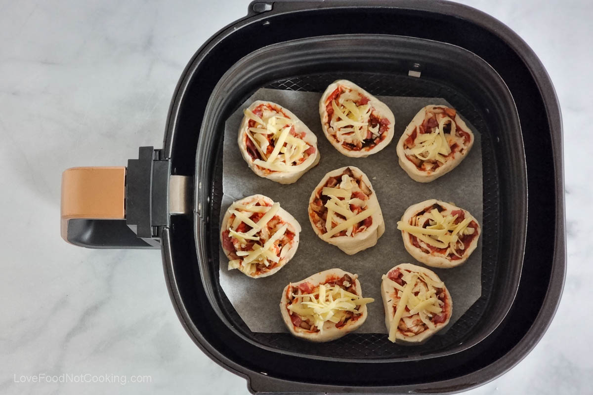 Pepperoni pizza rolls in air fyer basket. 