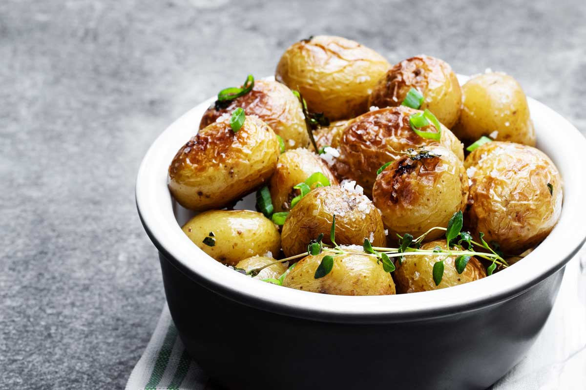 air fried baby potatoes in a black bowl. 