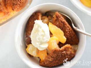 A bowl of air fryer peach cobbler with vanilla ice cream. Looks delicious!