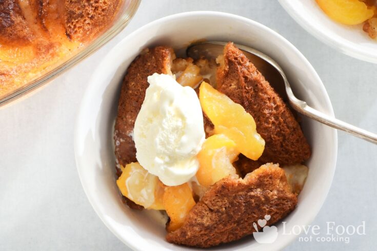A bowl of air fryer peach cobbler with vanilla ice cream. Looks delicious!