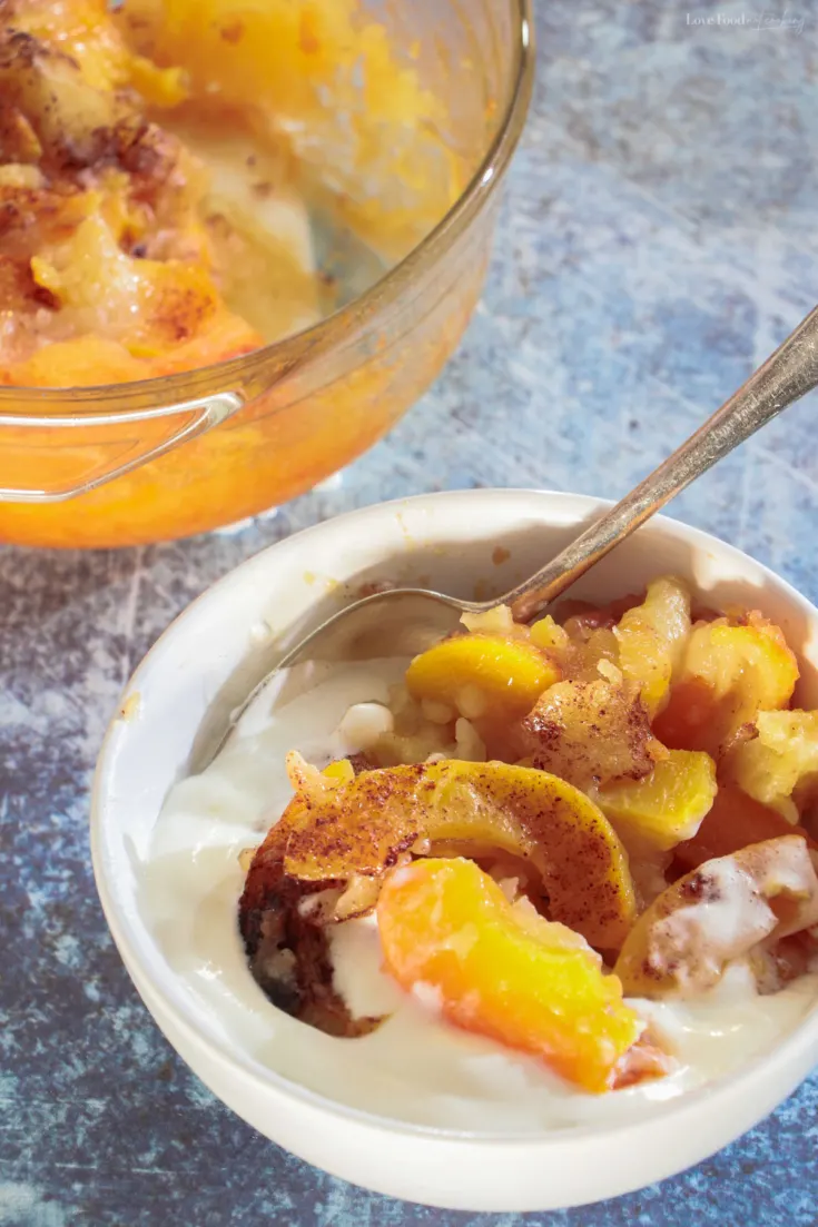 Peach cobbler in a serving dish and in a white bowl. 