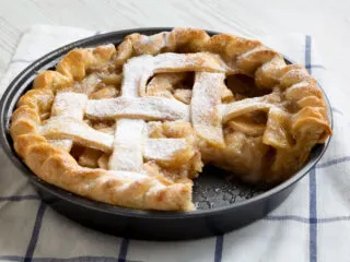 Air fryer apple pie on a chequered white cloth.