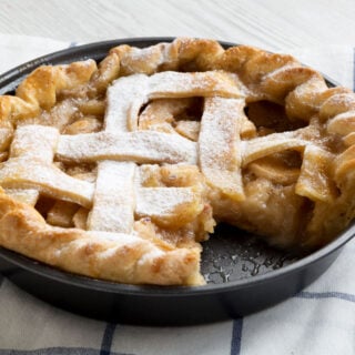 Air fryer apple pie on a chequered white cloth.