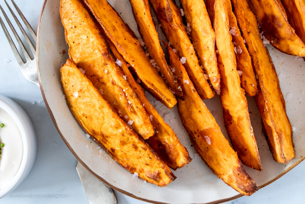 Air fryer sweet potato wedges on a white plate.