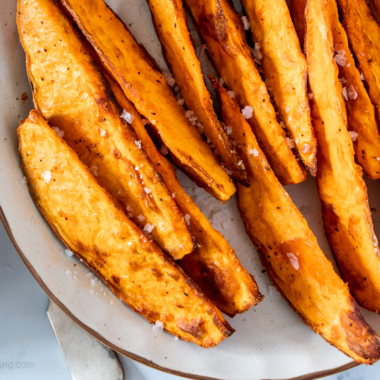 Air fryer sweet potato wedges on a white plate.