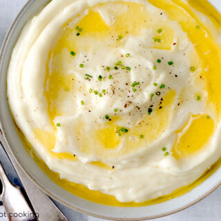 A bowl of Instant Pot mashed potato with butter melting on top.