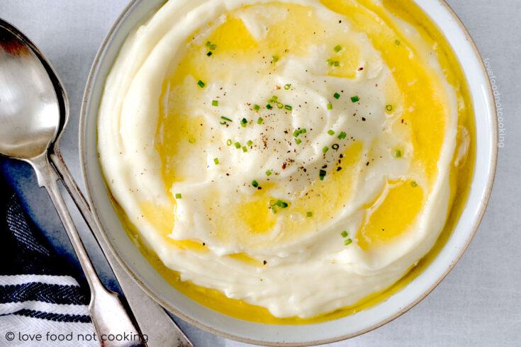 A bowl of Instant Pot mashed potato with butter melting on top.