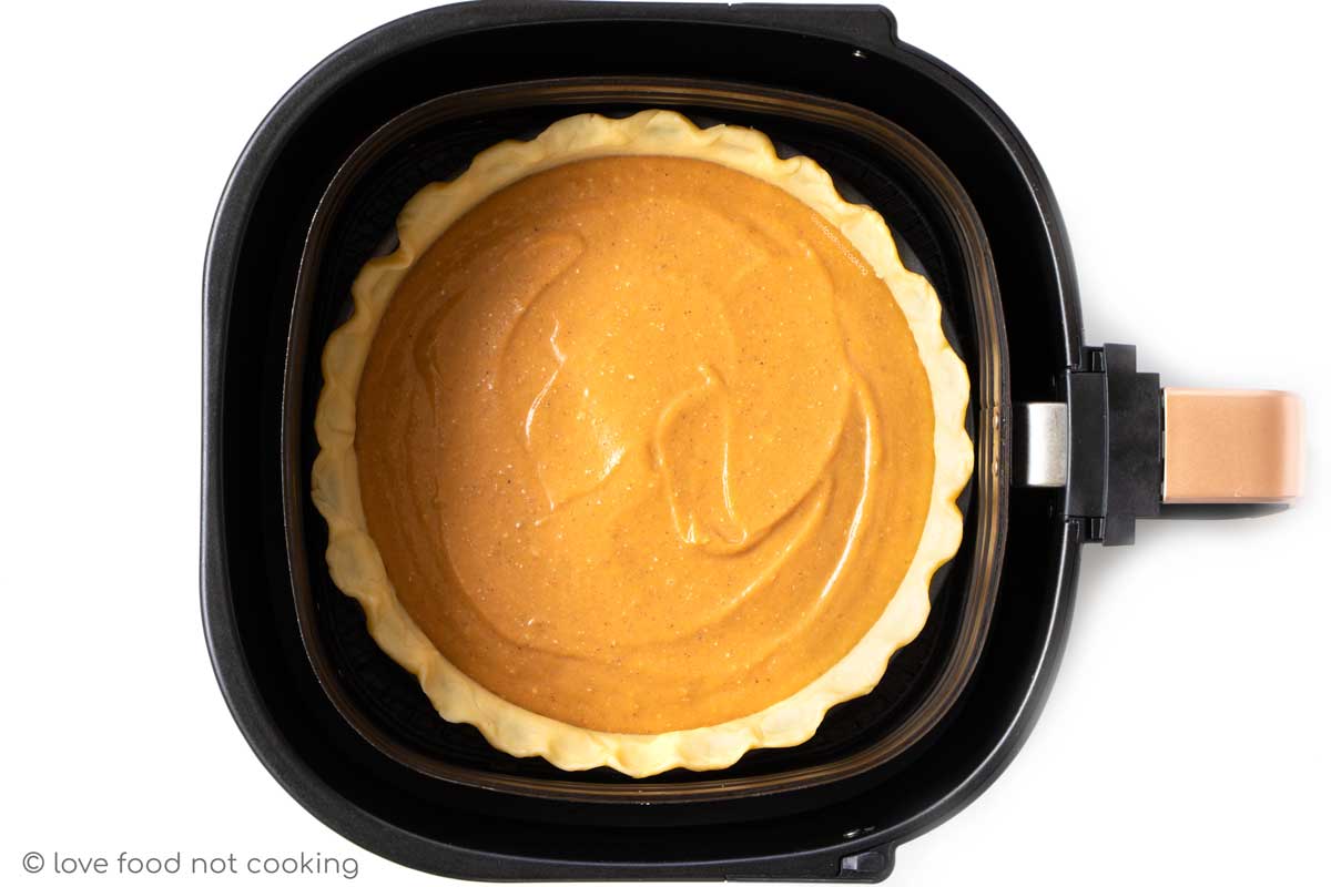 Pumpkin pie in air fryer basket. 