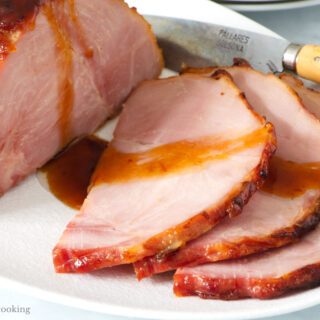 Air fried ham sliced on a white plate.