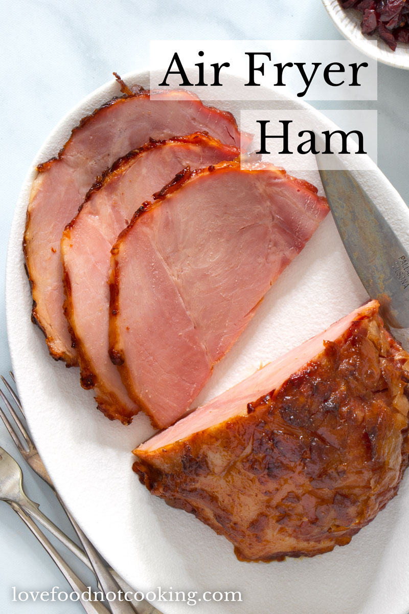 Flat lay image of of sliced ham on a white plate. 