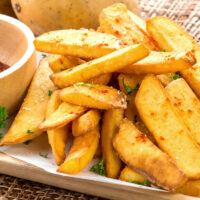 Air fryer steak fries with seasoning and bbq sauce.