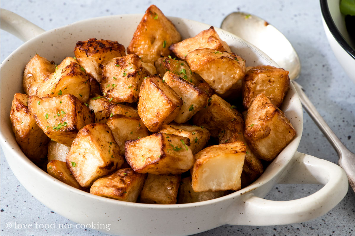 Air fried breakfast potatoes in a white bowl.