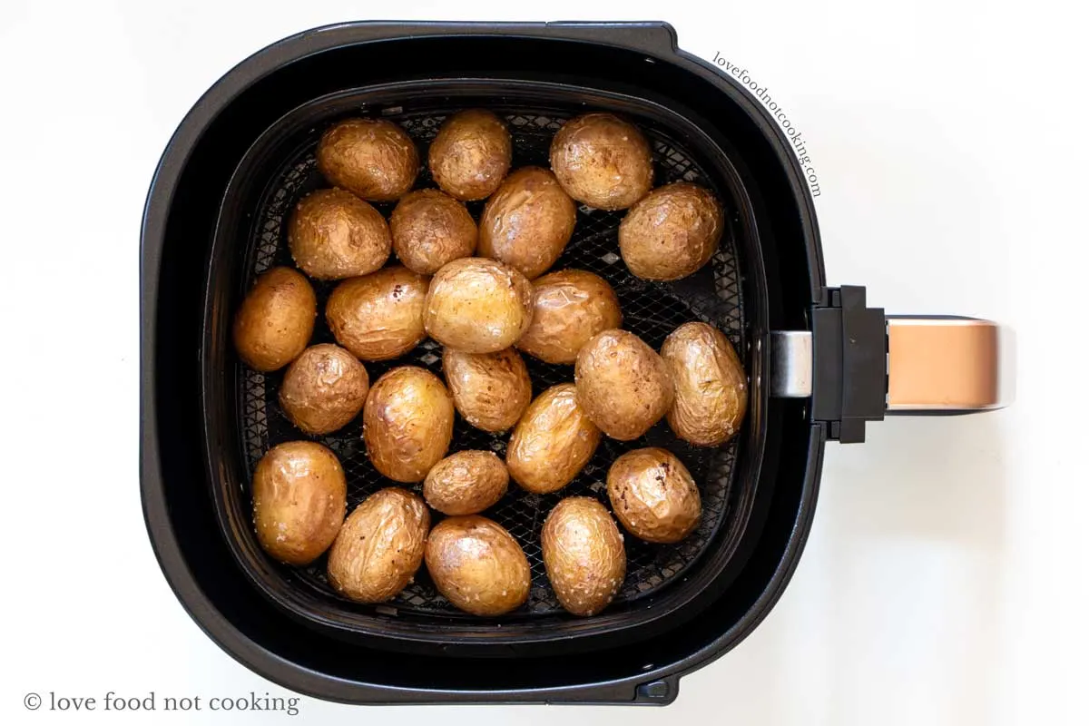 Air fried baby potatoes in air fryer basket. 