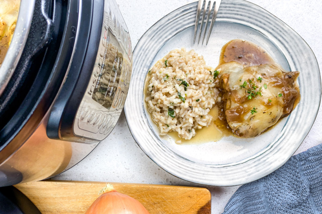 Instant Pot French onion chicken casserole on a blue plate with brown rice. 