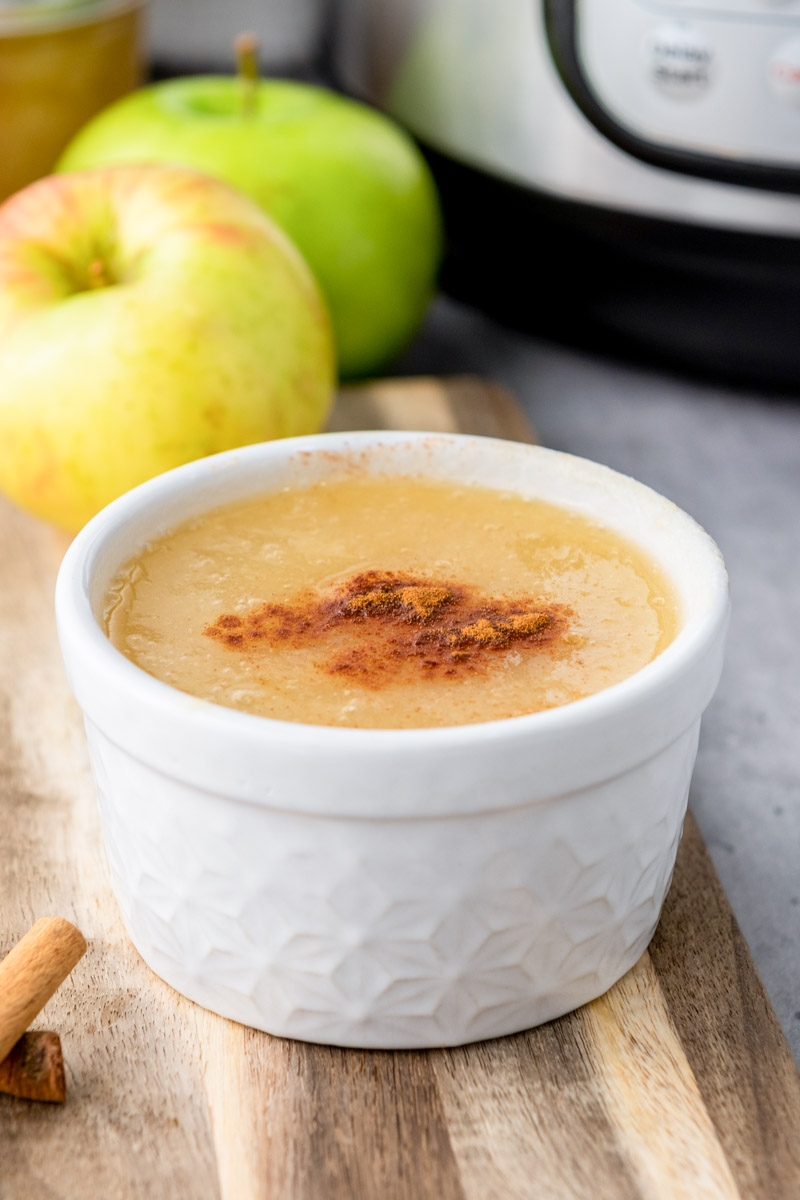 Pressure cooker applesauce in a white bowl. 