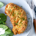 Air fryer chicken cutlets on a blue plate.