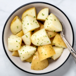 Instant Pot steamed potatoes in a white bowl.