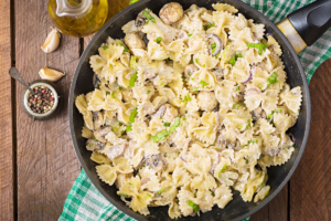 Sour cream pasta sauce with farfalle pasta and mushrooms.